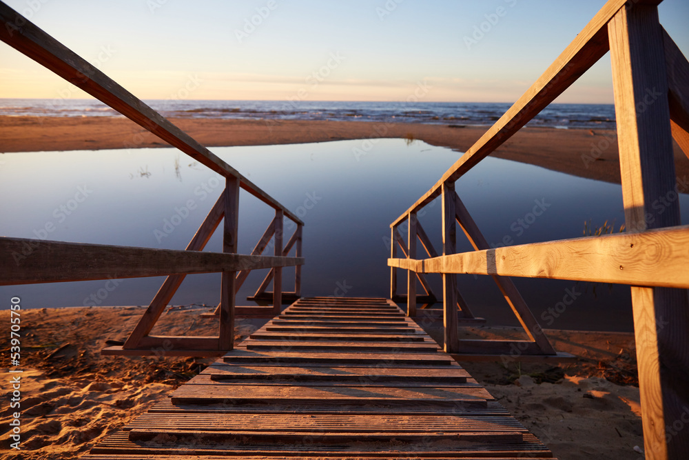Wooden path ramp going into water, selective focus Wooden path ramp going into water, selective focus