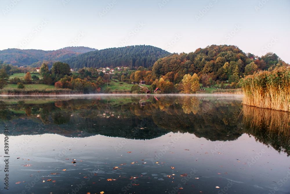 autumn color on the lake, beautiful yellow-red with reflection on the water autumn color on the lake, beautiful yellow-red with reflection on the water