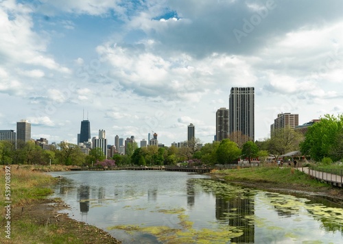 Beautiful view of Lincoln Park Zoo with a pond and buildings on the horizon in Chicago photo