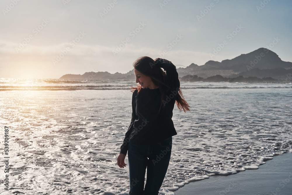 latin young woman enjoying sunset on the beach happy portrait