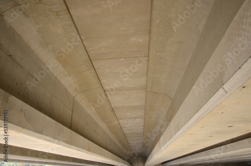 concrete highway bridge. looking at the bottom of the bridge is important to check for cracks and water moisture. the possibility of damage due to traffic loads