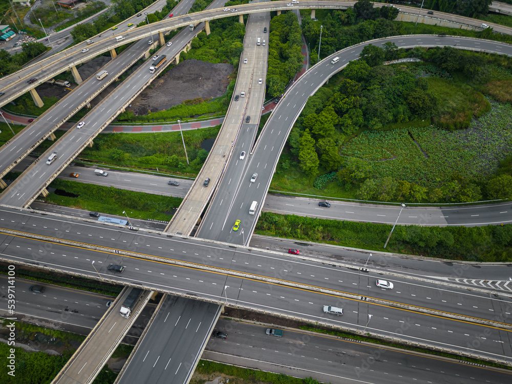 Aerial view city transport junction cross road with green public park transport industry