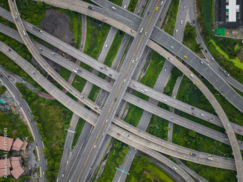 Aerial view city transport junction cross road with green public park transport industry