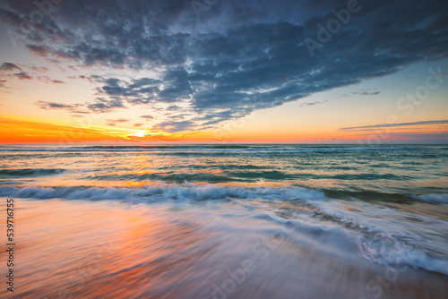 Beach sunrise over the tropical sea