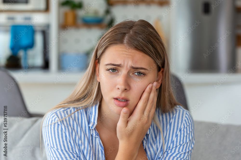 Portrait of unhappy woman suffering from toothache at home. Healthcare, dental health and problem concept. Stock photo Portrait of unhappy woman suffering from toothache at home. Healthcare, dental health and problem concept. Stock photo