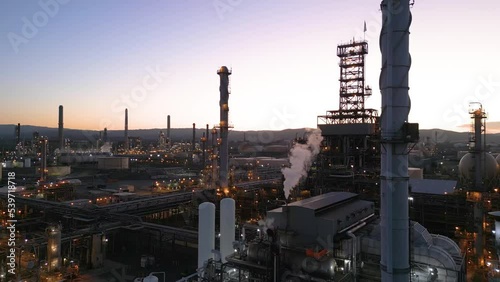 Shell Refinery polluting the air while manufacturing gasoline at dusk, Martinez California photo