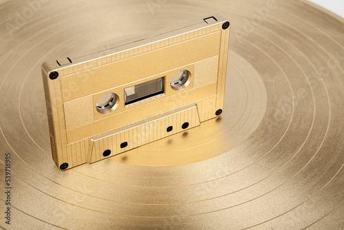 Vinyl record and cassette tape with recorded music photo