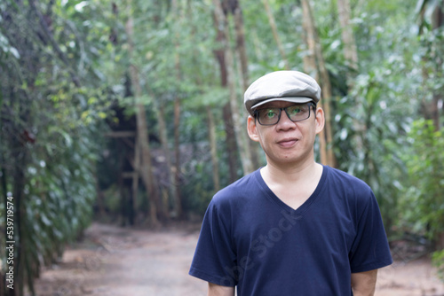 Portrait of a man enjoying walking in the woods agritourism, Slow life concept, vacation lifestyle alone. © Monta