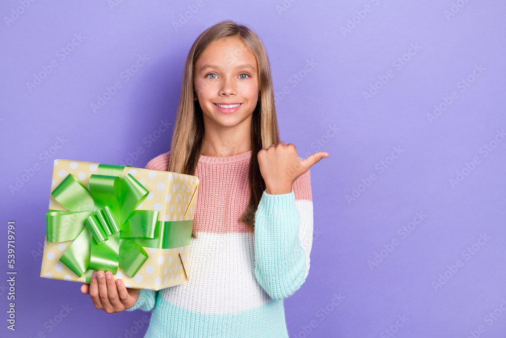 Photo of positive girl hand hold package arm direct empty space recommend nice shop party decor isolated on purple color background Photo of positive girl hand hold package arm direct empty space recommend nice shop party decor isolated on purple color background