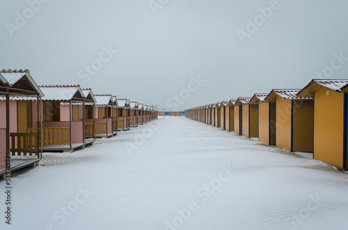 I capanni di uno stabilimento balneare del Lido di Venezia coperti dalla neve in una fredda giornata invernale  photo