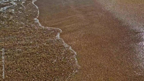 Waves of the mediterranean sea on the beach close up.