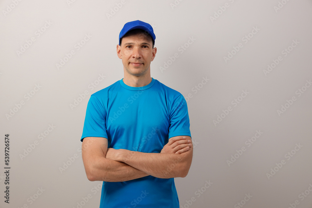 Portrait of a handsome attractive young man in a t-shirt and baseball cap.