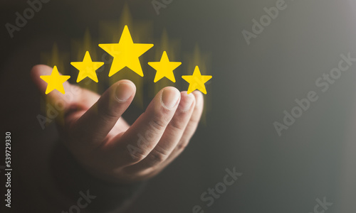 Photography Hand of the customer or client holding the stars to complete five stars