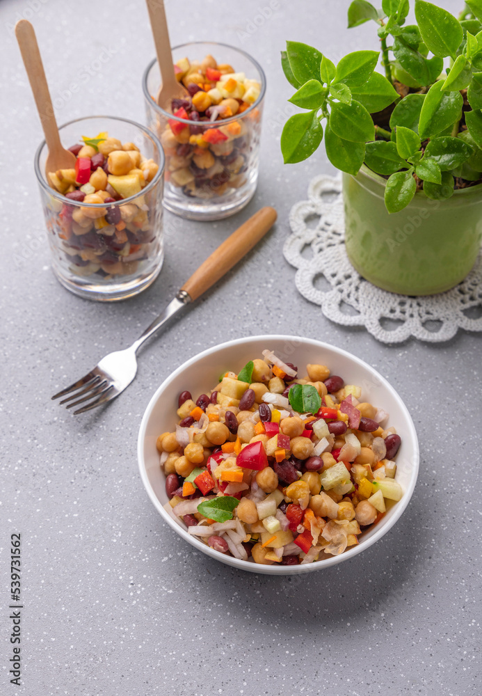 Overnight soaked legume salad of chickpea-kidney beans and other raw veggies mixed with herbs and mild spices