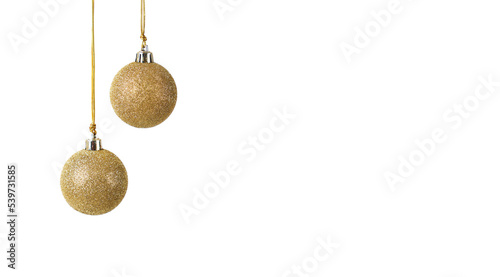 two golden Christmas balls with glitter hanging in front of a white background