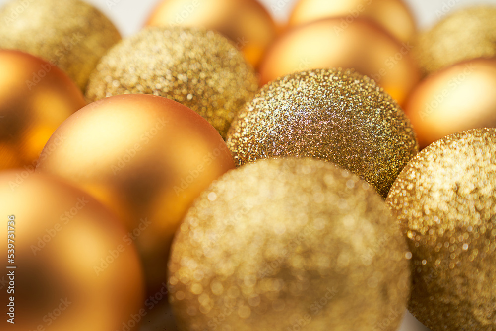 selective focus on golden Christmas balls with different textures and glitters selective focus on golden Christmas balls with different textures and glitters