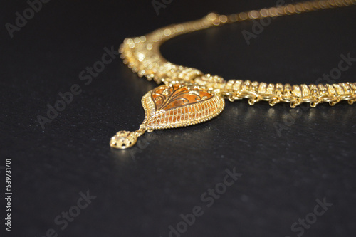 Authentic Indian Gold Jewelry Pendant. Selective Focus.