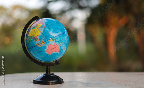 globe on white table in soft green nature background,Concept of global business study abroad education. photo
