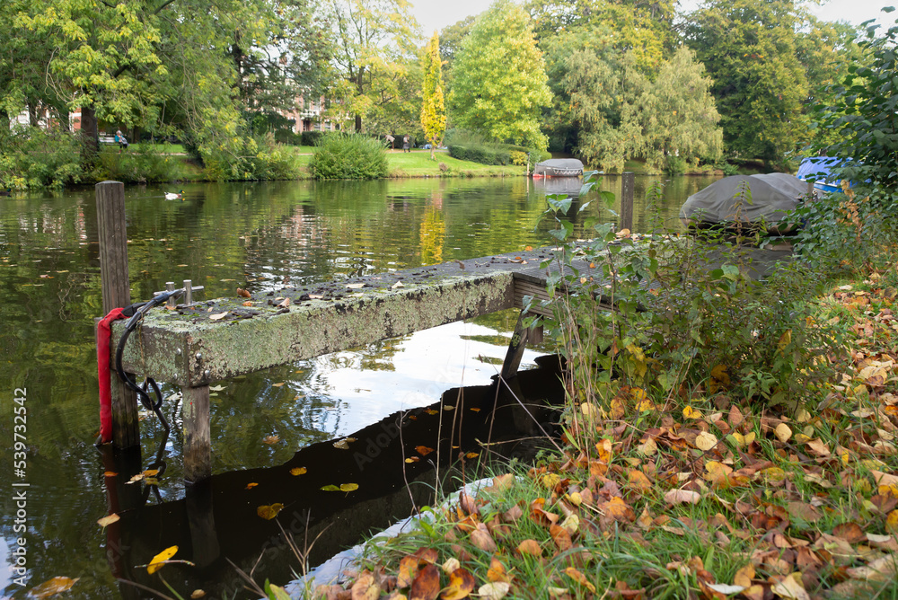 Boats in the waterway and colors of autumn in Plantsoen park, Leiden, Netherlands
