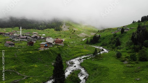Rize aerial view in foggy weather. Drone video over houses with a red roof, a mountain river flows nearby in Elevit, Turkey