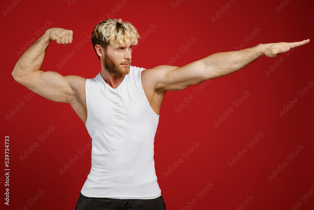 Young strong sporty sportsman man wear white clothes spend time in home ...