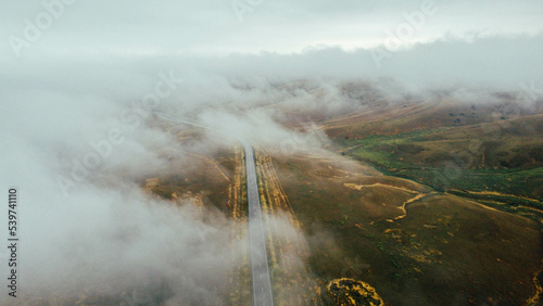 Cars are driving on the road in foggy weather - drone shots 