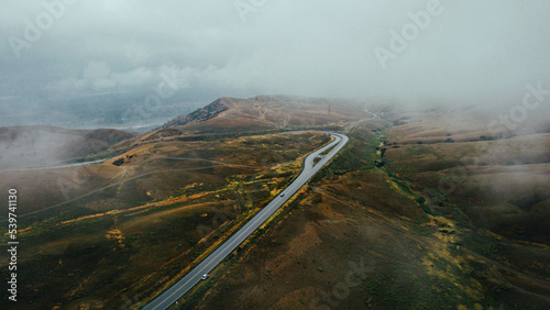 Cars are driving on the road in foggy weather - drone shots 