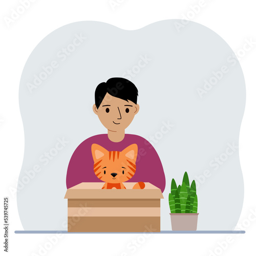 A boy is holding a cardboard box with a beautiful ginger cat. The concept of rescue, help and care for pets.