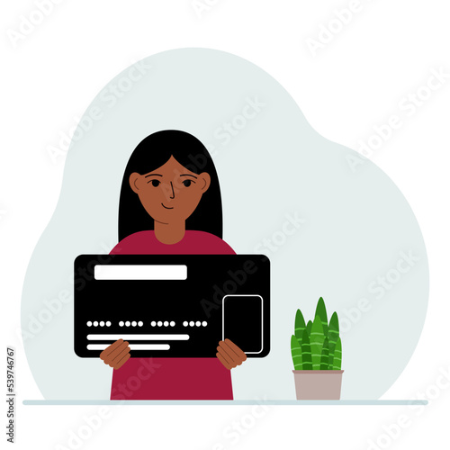 A girl holds a large credit card in his hands.