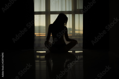Silhouette of a girl at the window