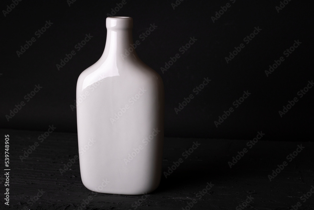white vase on the table on a black background white vase on the table on a black background