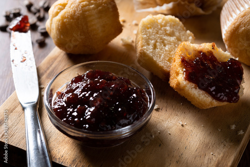 Muffins and raspberry jam on table photo