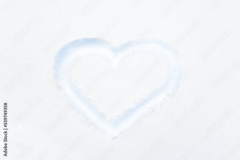 Blue heart shape drawing on white snow