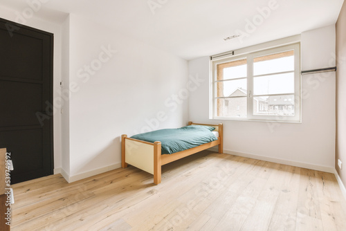 Bedroom with single bed near window photo