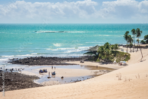 view of Genipabu beach on top of a giant dune photo