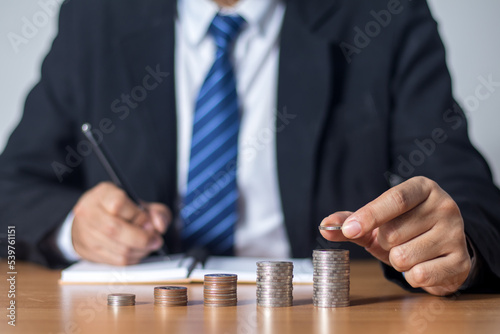 businessman holding a coin concept of saving money, investment, growth