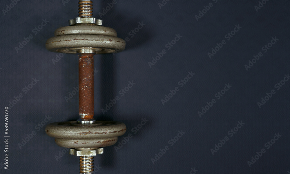 Old rusty iron dumbbells on the handles.fitness equipment background concept