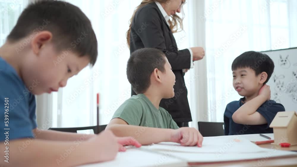 Kindergarten children enjoy drawing and painting in classroom. Kindergarten children enjoy drawing and painting in classroom.