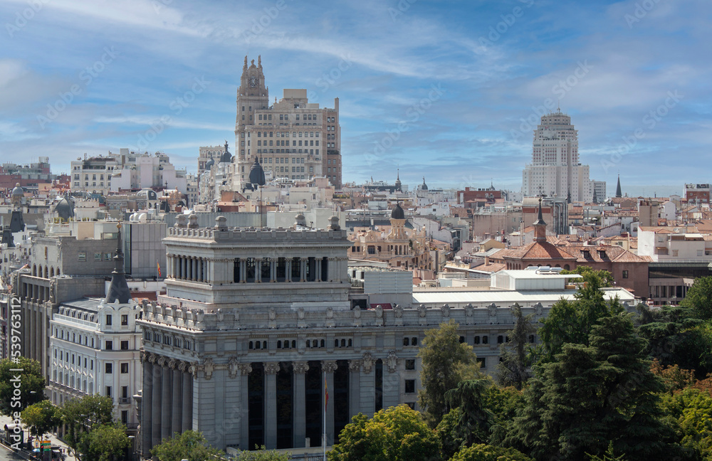 Skyline of Madrid, Spain, Europe. View from the tower of Cybele Palace. Buildings, towers, and colorful rooftops. European capital city skyline. Iconic buildings of Gran Vía avenue.