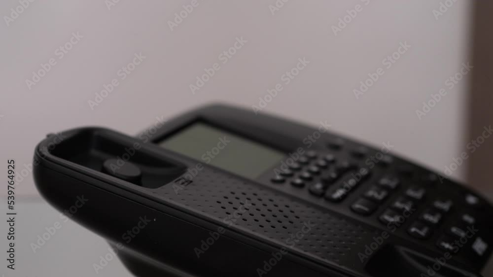 Close up of a female doctor's hand answering a phone call Close up of a female doctor's hand answering a phone call