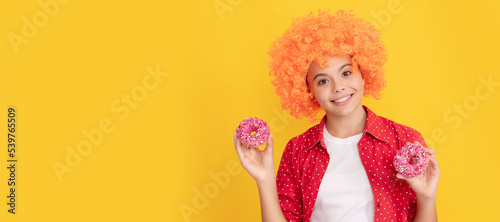 baked goods. sweet tooth. childhood happiness. yummy. happy nice child hold donut. Teenager child with sweets, poster banner header, copy space.