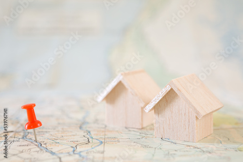 Selective focus of Red pin and house model on map background  for real estate concept