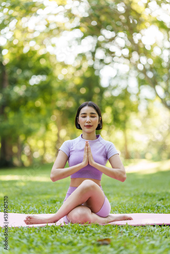 Pretty slim perfect body asian women wear sportswear to playing basic yoga compose. © NanSan