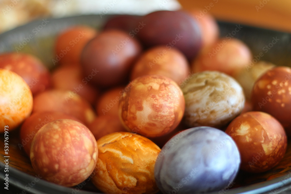 Spring season concept. Mix of colorful easter eggs with the traditional designs. Easter eggs dyed with onion peels with a pattern of fresh plants. Top view stock photo. Spring season concept. Mix of colorful easter eggs with the traditional designs. Easter eggs dyed with onion peels with a pattern of fresh plants. Top view stock photo.