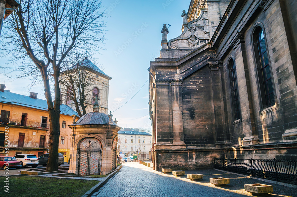 Bernardine church and narrow street in Old town of Lviv, Ukraine. Sunny weather in Lviv