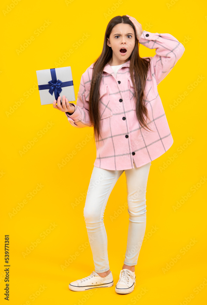 Emotional teenager child hold gift on birthday. Funny kid girl holding gift boxes celebrating happy New Year or Christmas. Surprised emotions of young teenager girl. Emotional teenager child hold gift on birthday. Funny kid girl holding gift boxes celebrating happy New Year or Christmas. Surprised emotions of young teenager girl.
