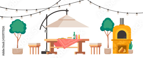 Backyard patio with furniture. Garden wooden table and chair with umbrella. Stone oven with firewood, plants