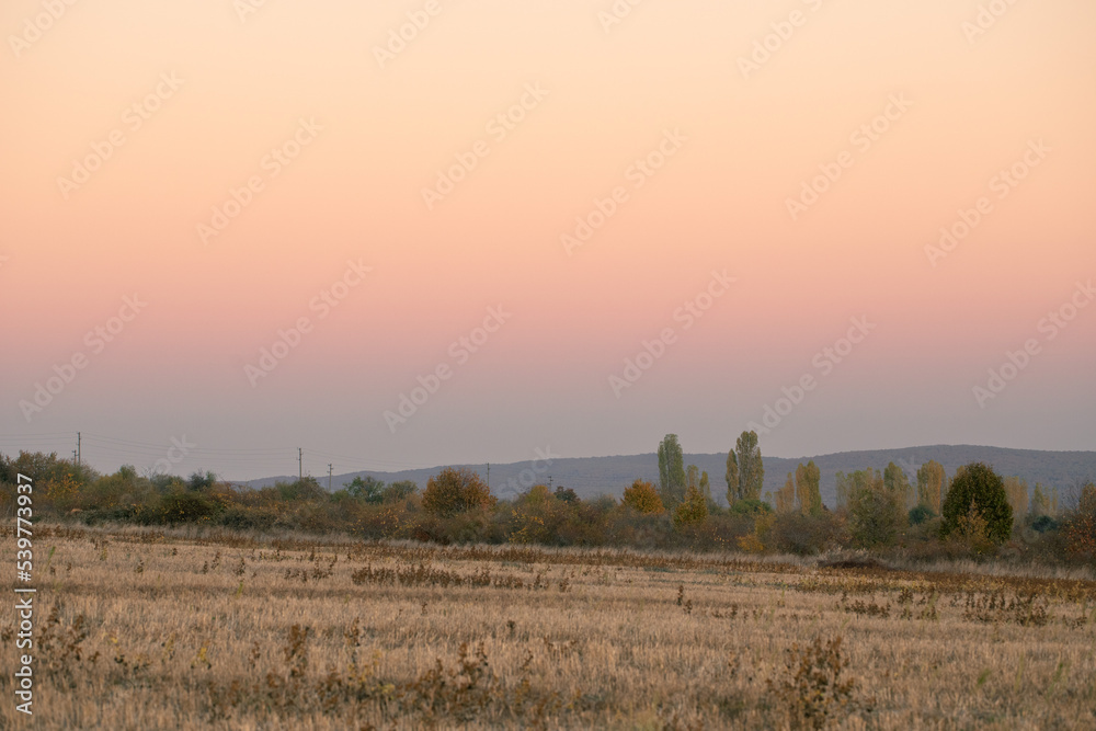Postoral view. Autumn fields at sunset.