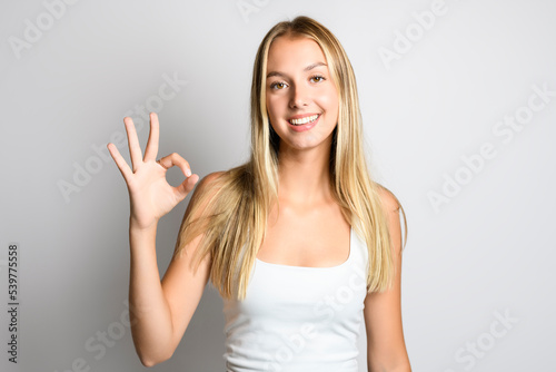 success Portrait of young beautiful cute girl looking at camera over white background.