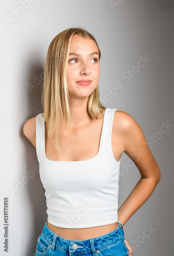 Portrait of young beautiful cute girl smiling over white background.
